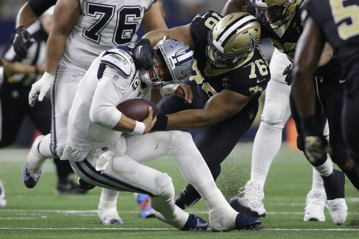 Nov 29, 2018; Arlington, TX, USA; Dallas Cowboys quarterback Dak Prescott (4) is tackled by New Orleans Saints defensive tackle Taylor Stallworth (76) in the fourth quarter at AT&T Stadium. Mandatory Credit: Tim Heitman-USA TODAY Sports